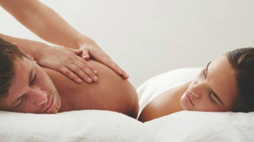 A couple laying down for massage