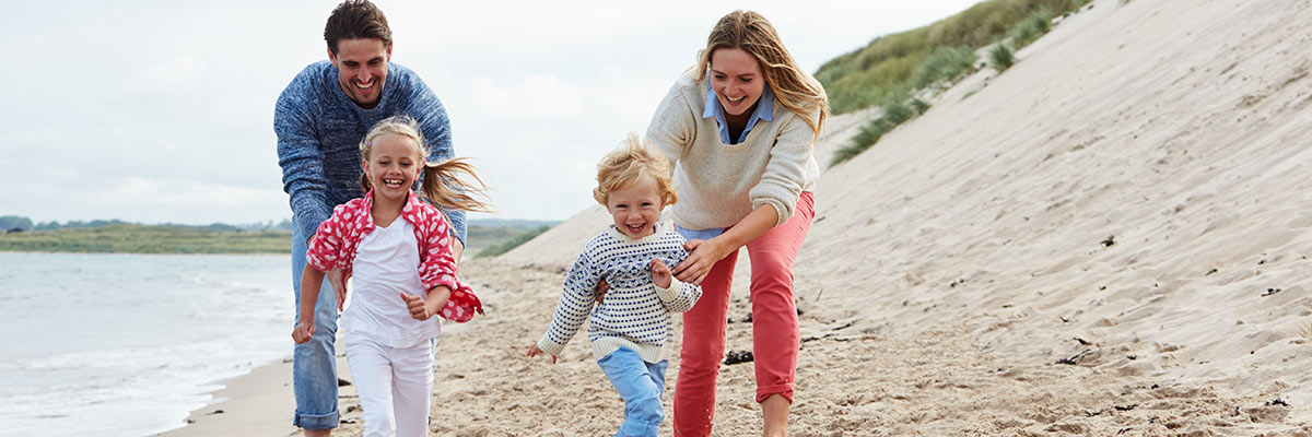 A happy family playing on the beach