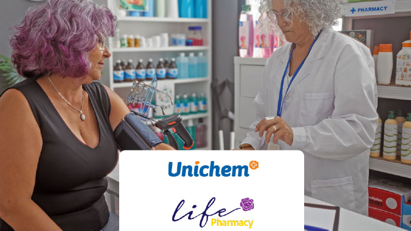 A person gets their blood pressure check in a pharmacy