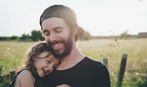 A smiling father and daughter