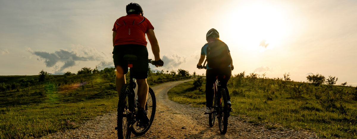 Two people cycling outdoors