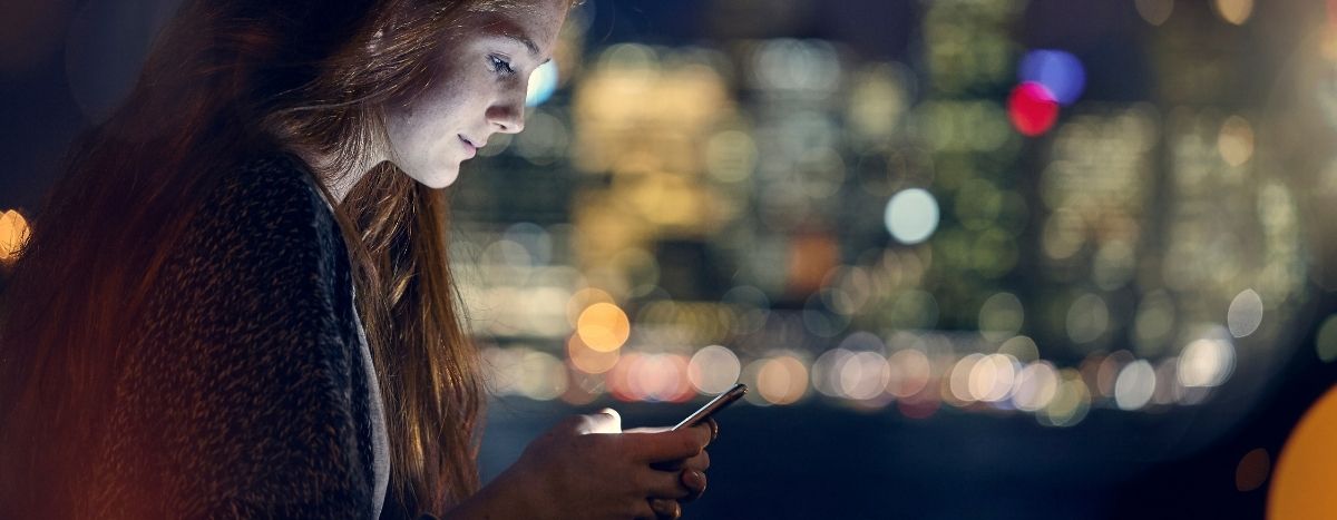 A woman looks at her phone
