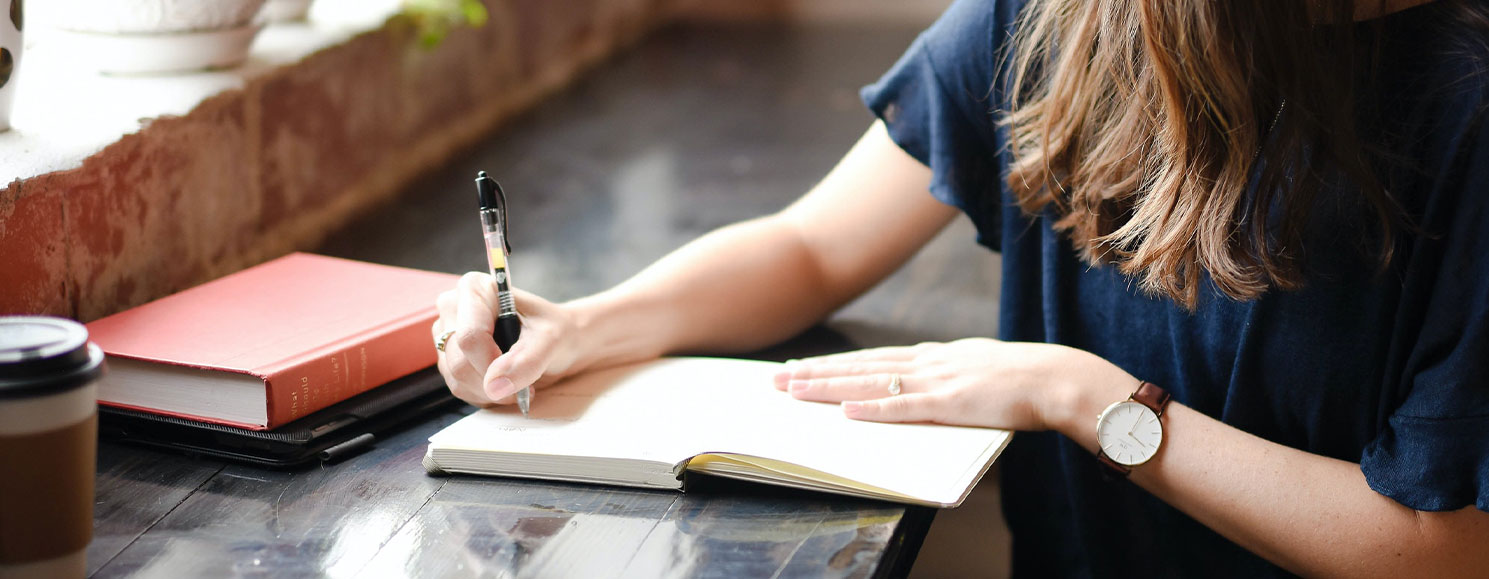 A woman writes in her journal