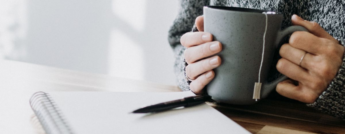 Closeup of hands holding a mug of tea