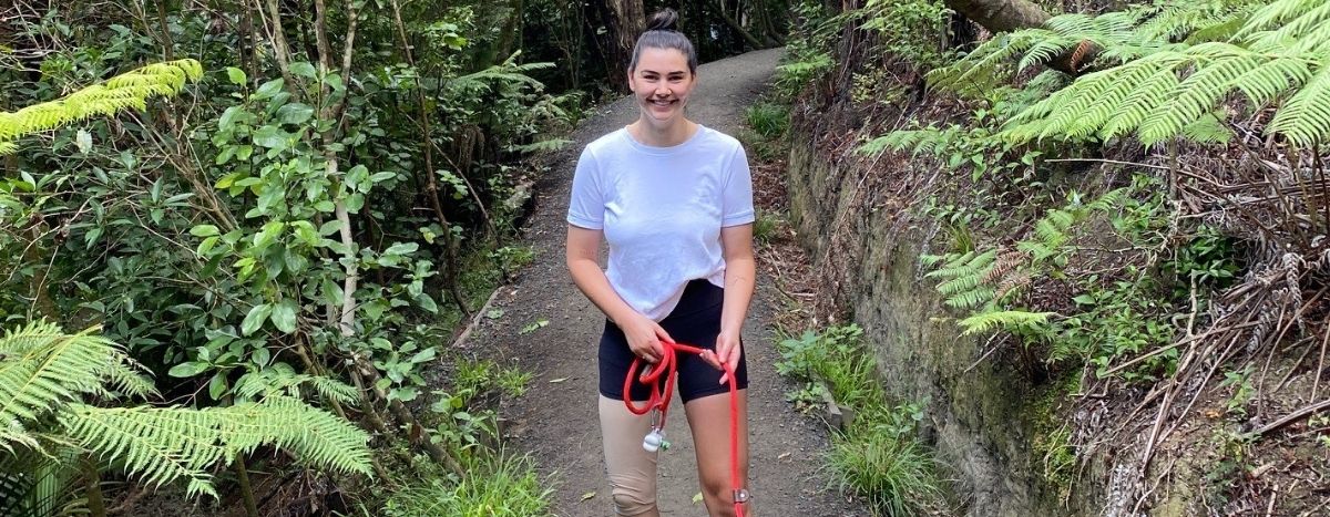 Jess Quinn walks her dog outdoors