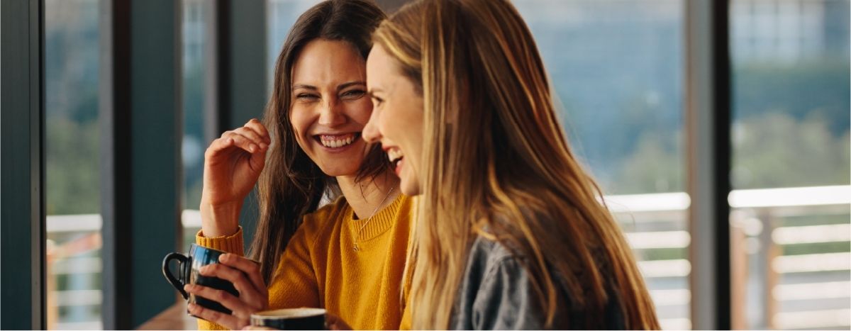 Friends laughing over coffee