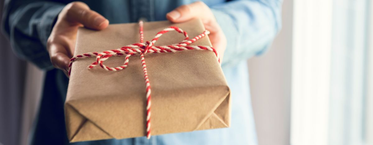 Someone giving a wrapped gift
