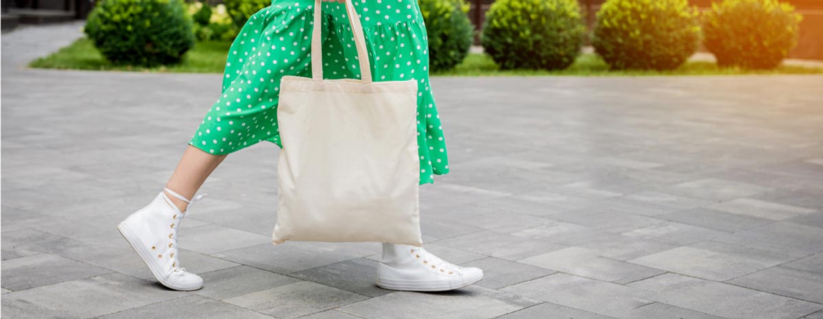 Person carrying a reusable shopping bag