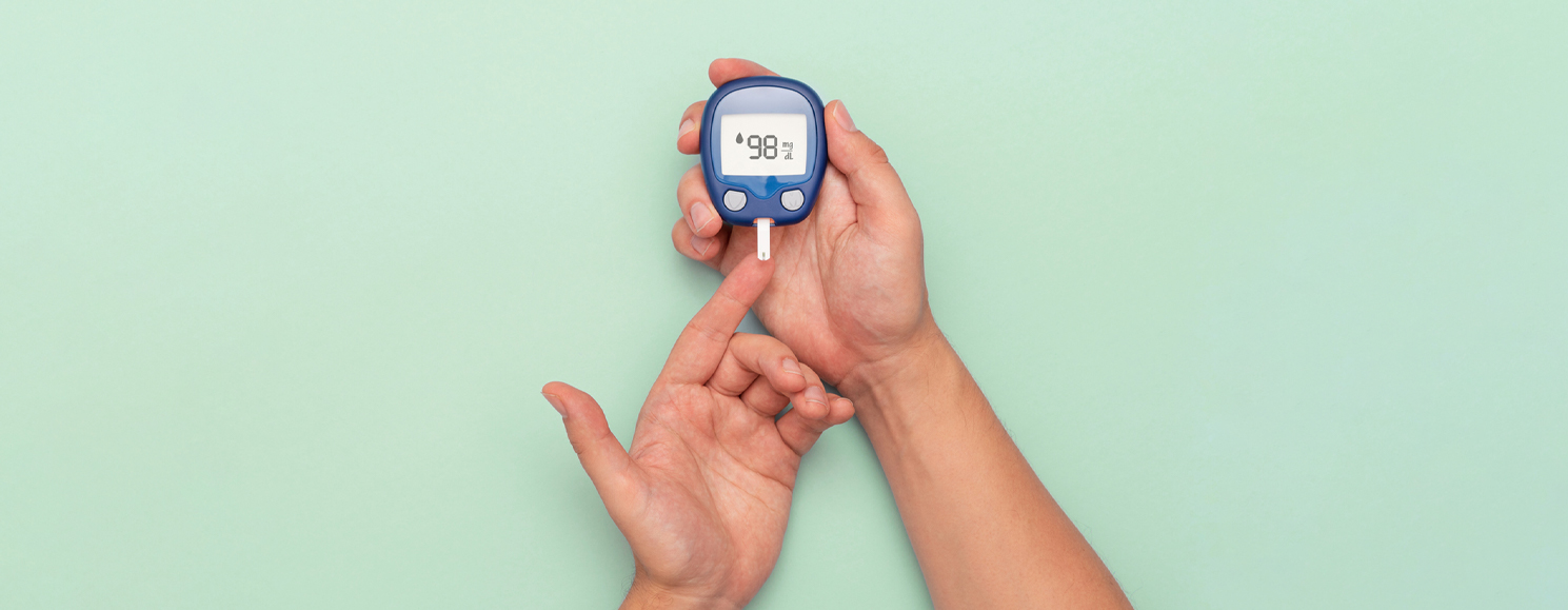 Image of two hands performing diabetes prick test