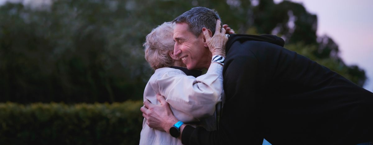 AIA Vitality Ambassador Ian Jones hugging another person