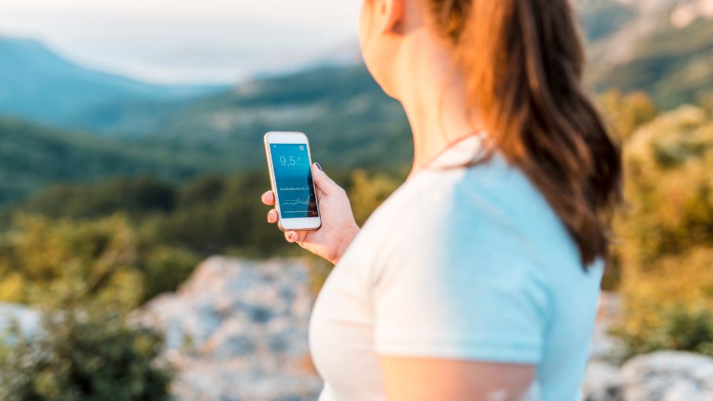 AIA Vitality | Move more to manage diabetes | image of person holding phone that is measuring blood glucose levels