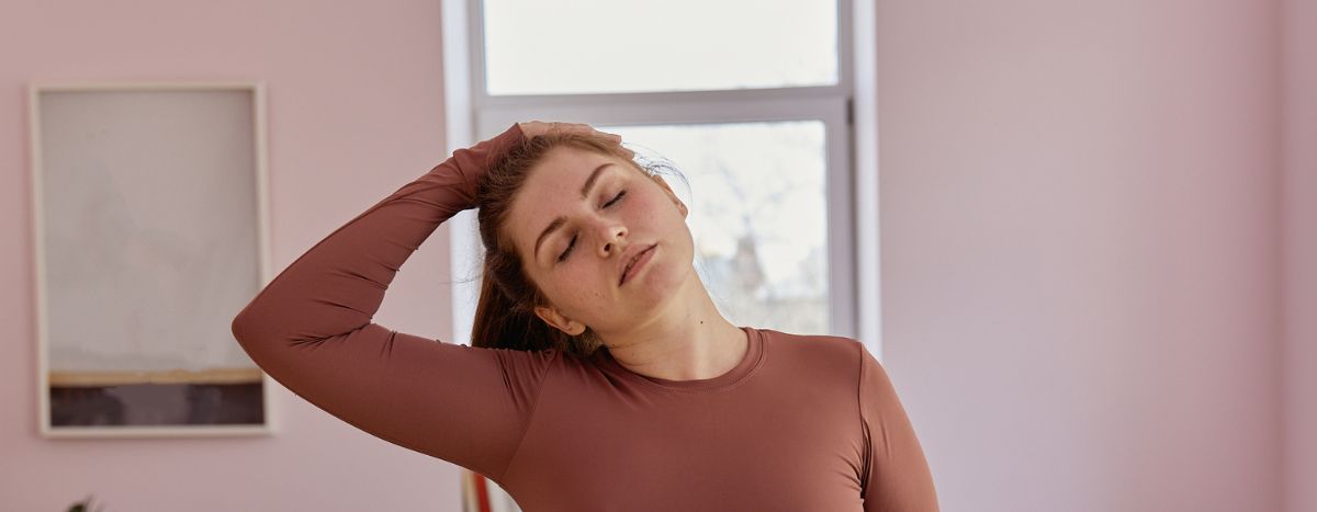 Person tilting head to one side and stretching neck