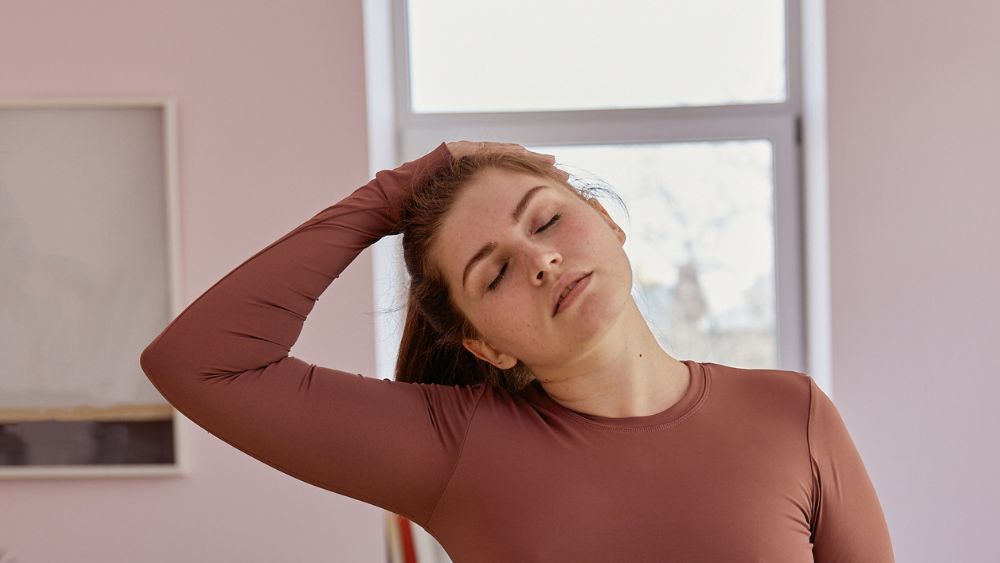 Person leaning to one side stretching neck 