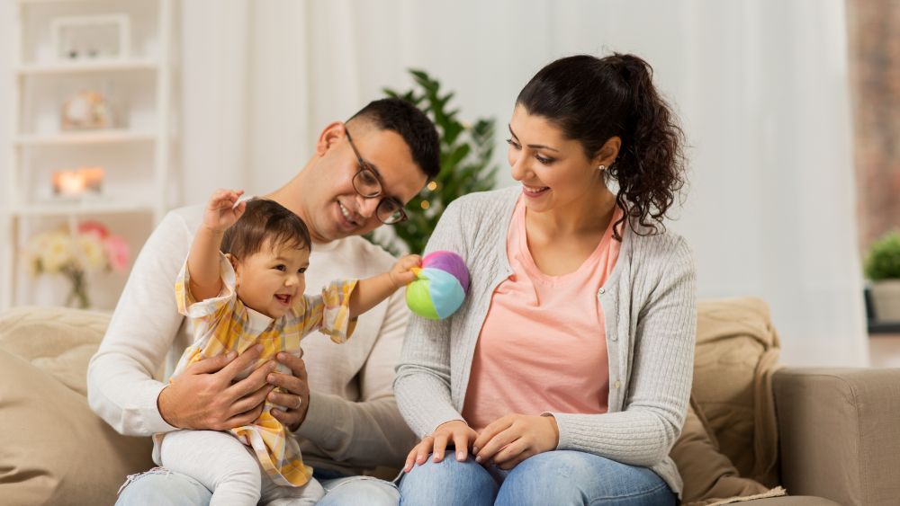 Family with child playing on the lap of one of the parents