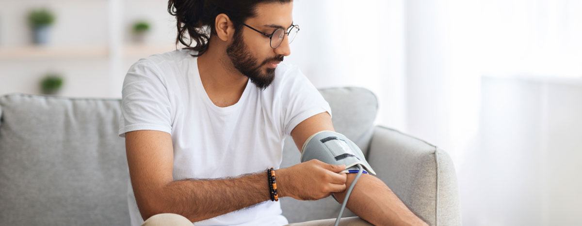 A person using a blood pressure monitor.