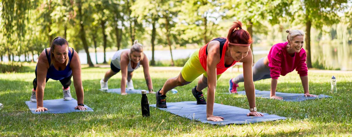 A group of women doing Yoga outside