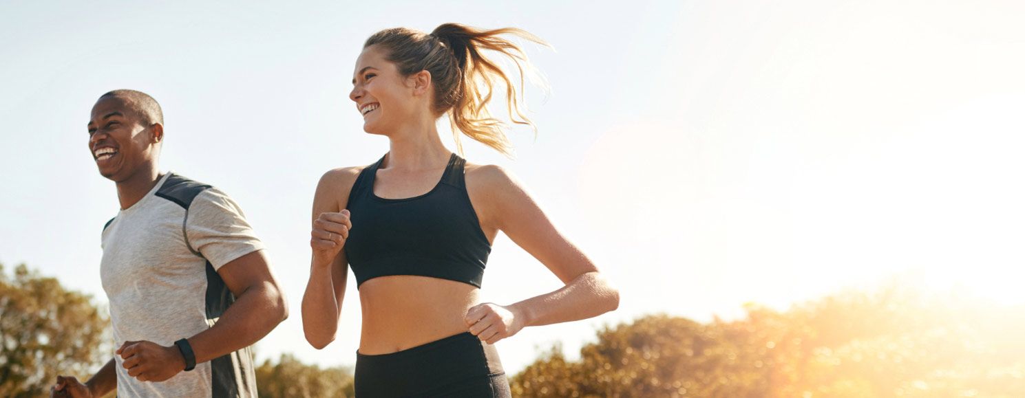 Man and woman active running outdoors