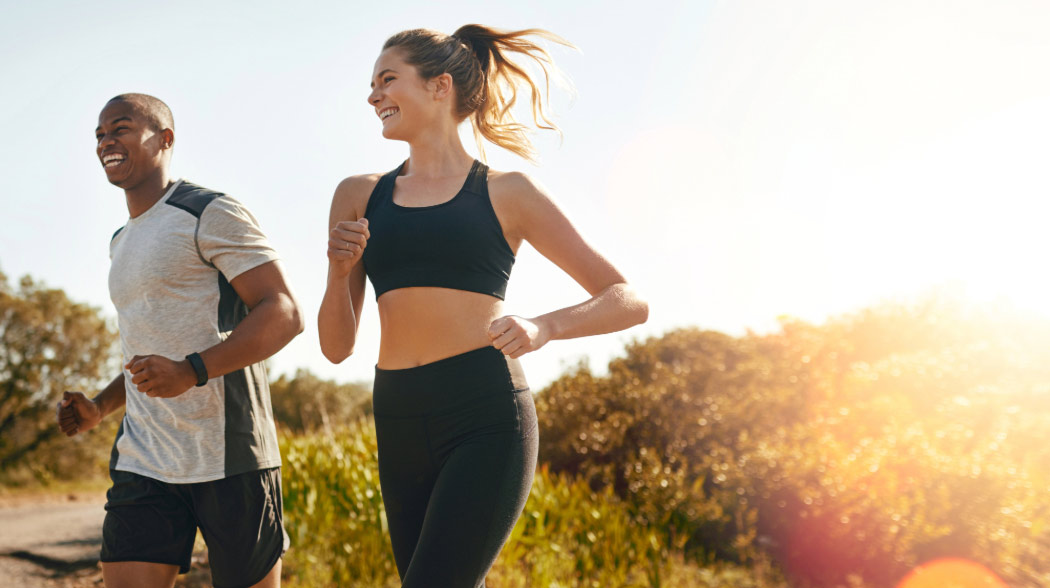 Man and woman active running outdoors