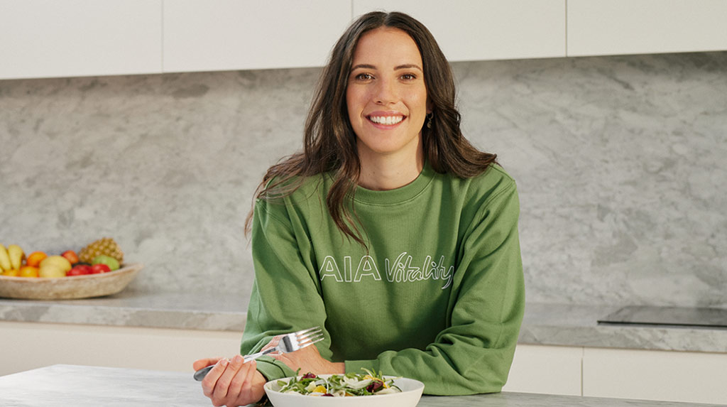 Marika Day in the kitchen with Green AIA Vitality Jumper
