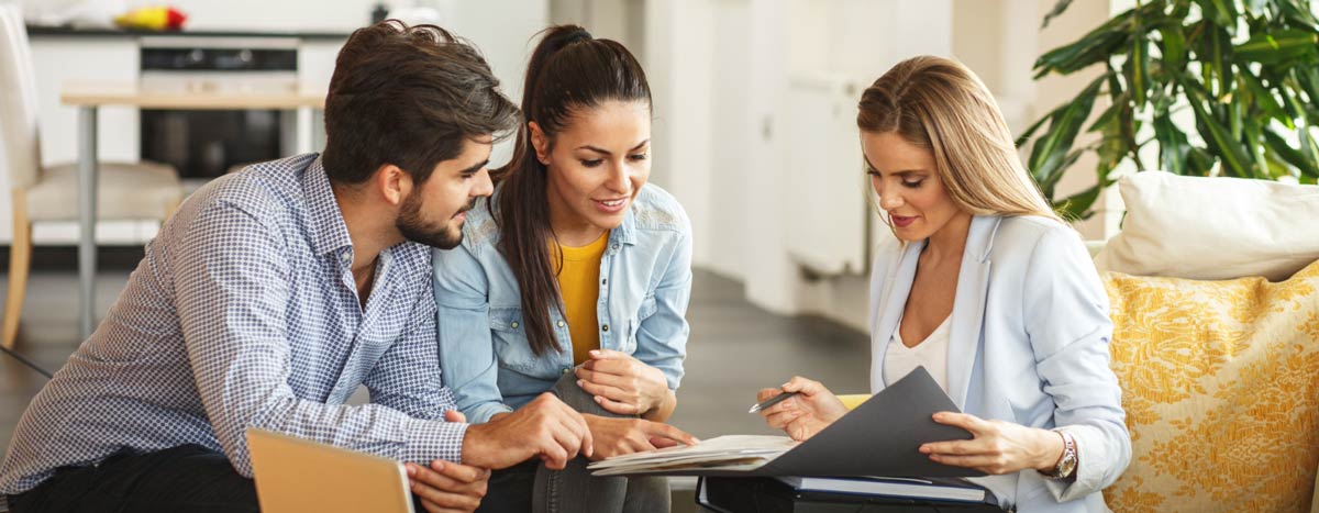 Couple reviewing documents with advisor