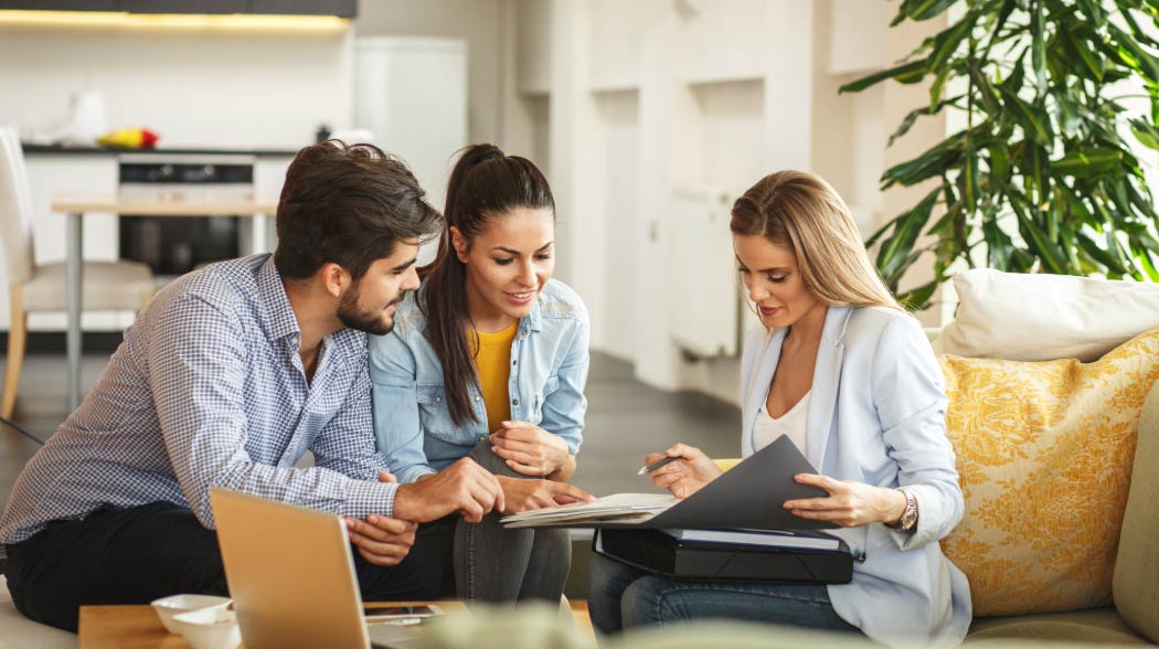 Couple reviewing documents with advisor
