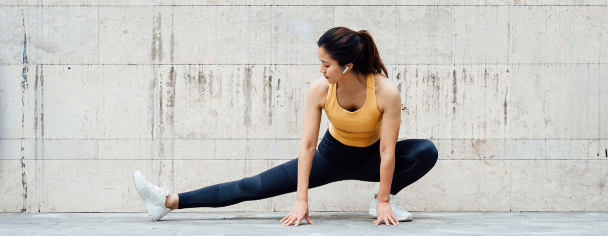 Woman stretching legs outdoors