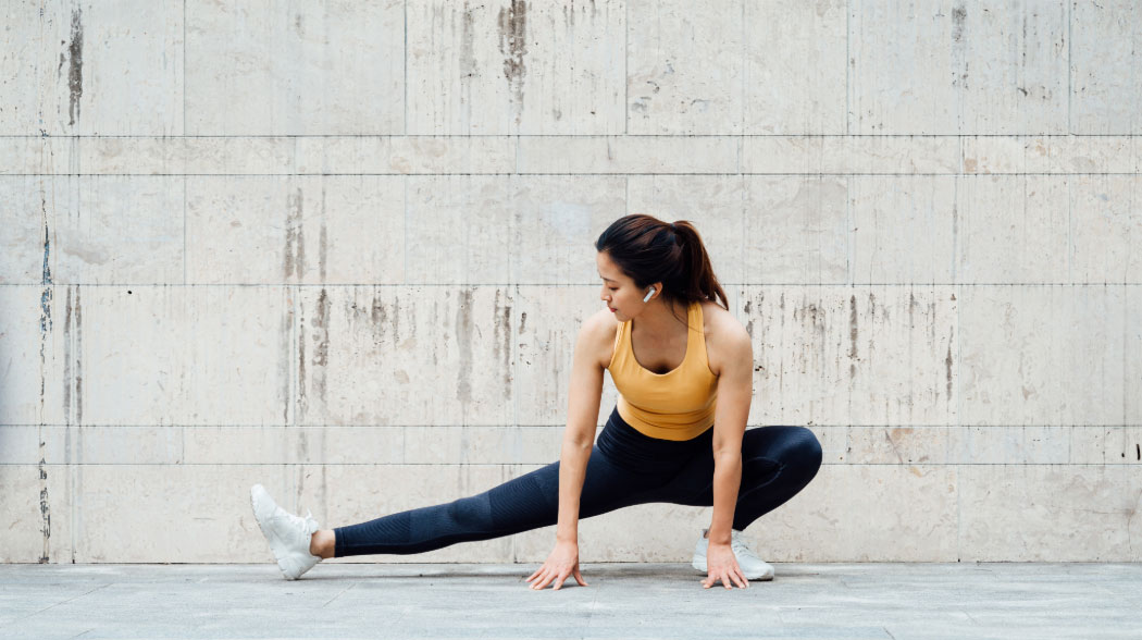 Woman stretching legs outdoors