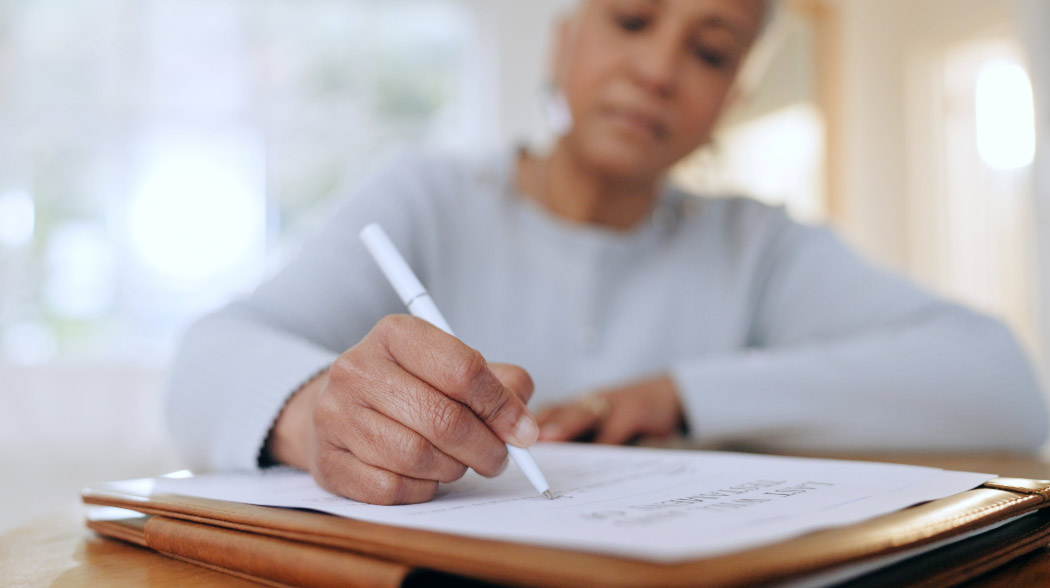 Woman writing on paper - Will's Month | Footprint